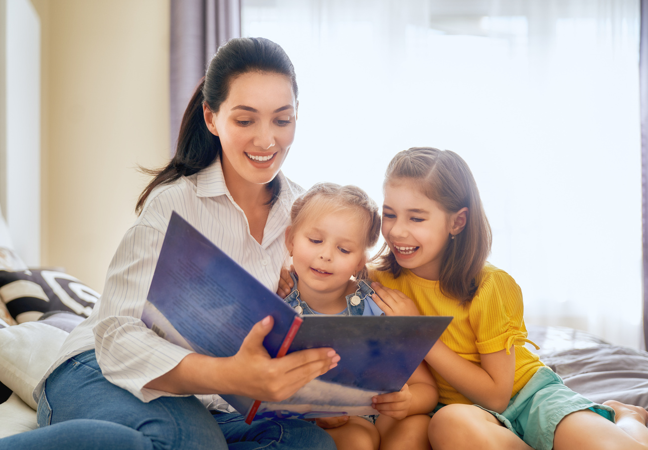 Mom and children reading a book